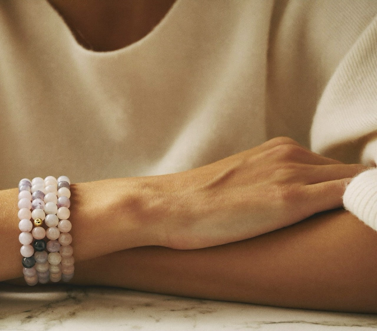 Crystal bracelets stacked on a wrist